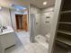 Bright bathroom featuring a glass shower with a bench, gray tile, and marble floors at 187 Alston Rd., Pawleys Island, SC 29585