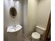 Half bath with a pedestal sink, decorative mirror and low-flow toilet at 187 Alston Rd., Pawleys Island, SC 29585