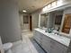 Dual vanity bathroom with a bright, full-width mirror and walk-in shower at 187 Alston Rd., Pawleys Island, SC 29585