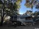 Exterior view of raised beach house with screened porch and outdoor shower at 187 Alston Rd., Pawleys Island, SC 29585
