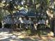 Charming raised beach house with covered porch, surrounded by mature trees at 187 Alston Rd., Pawleys Island, SC 29585