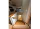 View of wooden staircase with white walls and trim leading to lower level with hardwood flooring at 187 Alston Rd., Pawleys Island, SC 29585