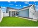 Spacious backyard with lush green grass, a privacy fence, and home exterior at 2023 Singing Palm Loop, Little River, SC 29566