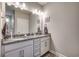 Bathroom featuring double sink vanity with granite countertop and bronze fixtures at 2023 Singing Palm Loop, Little River, SC 29566