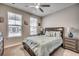 Cozy bedroom with carpet floors, ceiling fan and a street view from its double windows at 2023 Singing Palm Loop, Little River, SC 29566