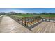 Scenic community park view from a wooden overlook with seating and green space at 2023 Singing Palm Loop, Little River, SC 29566