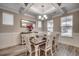 Elegant dining room with decorative lighting, paneled walls, wood table and seating for six at 2023 Singing Palm Loop, Little River, SC 29566