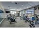 Fitness center equipped with modern cardio machines, weights, and a wall of windows at 2023 Singing Palm Loop, Little River, SC 29566