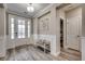 Inviting foyer with wood floors, white wainscoting, bench and front door with frosted glass at 2023 Singing Palm Loop, Little River, SC 29566