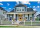 Charming two-story home with a covered porch, white picket fence and nicely landscaped front yard at 2023 Singing Palm Loop, Little River, SC 29566