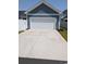 Detached two-car garage in a fenced backyard with a concrete drive at 2023 Singing Palm Loop, Little River, SC 29566