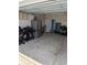 View of the garage with stainless steel refrigerator and a rolling toolbox at 2023 Singing Palm Loop, Little River, SC 29566