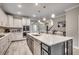 Bright kitchen features white cabinets, stainless steel appliances, subway tile backsplash and large center island at 2023 Singing Palm Loop, Little River, SC 29566