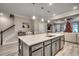 Kitchen island with a gray base, a white countertop, stainless steel sink and seating for three at 2023 Singing Palm Loop, Little River, SC 29566