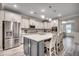 Modern kitchen features a large island with seating, stainless steel appliances, and designer tile backsplash at 2023 Singing Palm Loop, Little River, SC 29566