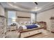 Spacious main bedroom with tray ceiling, ceiling fan, sitting area, and carpet floors at 2023 Singing Palm Loop, Little River, SC 29566