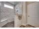 Beautiful walk-in shower with marble tiling, a rain shower head and a built-in bench at 2023 Singing Palm Loop, Little River, SC 29566