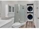 Bathroom with shower, toilet, vanity, and stackable washer/dryer at 3943 Gladiola Ct. # 204, Myrtle Beach, SC 29588