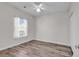 Bright bedroom with hardwood floors, large window, and ceiling fan at 3943 Gladiola Ct. # 204, Myrtle Beach, SC 29588