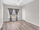 Empty bedroom with wood-look floors and a window with gray curtains at 3943 Gladiola Ct. # 204, Myrtle Beach, SC 29588