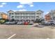 Inviting exterior of a multi-unit building with ample parking at 3943 Gladiola Ct. # 204, Myrtle Beach, SC 29588