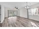 Spacious living room with wood-look floors and access to a balcony at 3943 Gladiola Ct. # 204, Myrtle Beach, SC 29588
