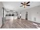 Open living room with kitchen and dining area, hardwood floors, and ceiling fan at 3943 Gladiola Ct. # 204, Myrtle Beach, SC 29588