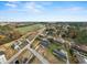 Expansive aerial view of a quiet neighborhood under a clear blue sky with scattered clouds at 412 E Melrose St., Mullins, SC 29574