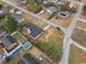 Overhead shot showcasing the property, its manicured lawn, and surrounding residential area at 412 E Melrose St., Mullins, SC 29574