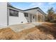 Exterior view of a brick home with dark trim and a covered patio area is shown, with a small yard at 412 E Melrose St., Mullins, SC 29574