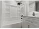 Bright bathroom showcasing a bathtub with shower and a modern vanity with a sleek, illuminated mirror at 412 E Melrose St., Mullins, SC 29574