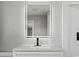 Close-up of bathroom vanity with a modern illuminated mirror, a sleek faucet, and stylish countertop at 412 E Melrose St., Mullins, SC 29574