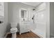 Modern bathroom featuring a sleek vanity, illuminated mirror, and walk-in shower with a black shower head at 412 E Melrose St., Mullins, SC 29574