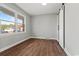 Bedroom with wood floors, natural light from a large window, and a closet with a modern barn door at 412 E Melrose St., Mullins, SC 29574