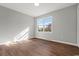 Light-filled bedroom features a large window and wood-look floors at 412 E Melrose St., Mullins, SC 29574