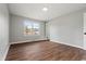 Neat bedroom with sleek floors, soft gray walls, and a sunlit window at 412 E Melrose St., Mullins, SC 29574