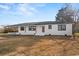 The front of a single-story, brick home with dark trim and a small front yard with a driveway is shown at 412 E Melrose St., Mullins, SC 29574