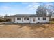 A single-story home has a brick exterior and dark trim, with a small front yard and driveway at 412 E Melrose St., Mullins, SC 29574