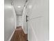 Hallway with wood floors, white doors, and sliding barn door at 412 E Melrose St., Mullins, SC 29574