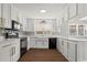 Updated kitchen with white cabinets, quartz countertops, and black stainless-steel appliances at 412 E Melrose St., Mullins, SC 29574