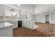 Open concept kitchen with bar and view to the main living space fireplace at 412 E Melrose St., Mullins, SC 29574