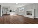 Open living room with wood floors, white brick fireplace, and wainscoting walls at 412 E Melrose St., Mullins, SC 29574