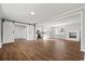 Open-concept living room boasts wood floors, barn doors, fireplace and views to the kitchen at 412 E Melrose St., Mullins, SC 29574