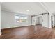 Spacious living room featuring wood floors, large window, and elegant barn door at 412 E Melrose St., Mullins, SC 29574