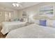 Inviting bedroom featuring two queen beds, ceiling fan, wall art, and a view into the adjacent room at 603 S Ocean Blvd. # 1002, North Myrtle Beach, SC 29582