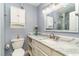 Bathroom features a marble countertop, decorative mirror and white cabinets at 775 Plantation Dr. # 59, Little River, SC 29566