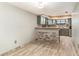 Dining area showing tile floor, wainscoting accent, view into the kitchen at 775 Plantation Dr. # 59, Little River, SC 29566