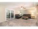 Cozy living area with plush carpeting, sliding glass doors, and comfortable furniture at 775 Plantation Dr. # 59, Little River, SC 29566