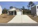 Charming single-story home with a one-car garage and a long driveway and some budding landscaping at 1016 Sw Maple View Rd., Supply, SC 28462