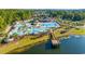 Aerial view of community pool, clubhouse and splashpad area with lake and pier at 128 Fulbourn Pl., Myrtle Beach, SC 29579